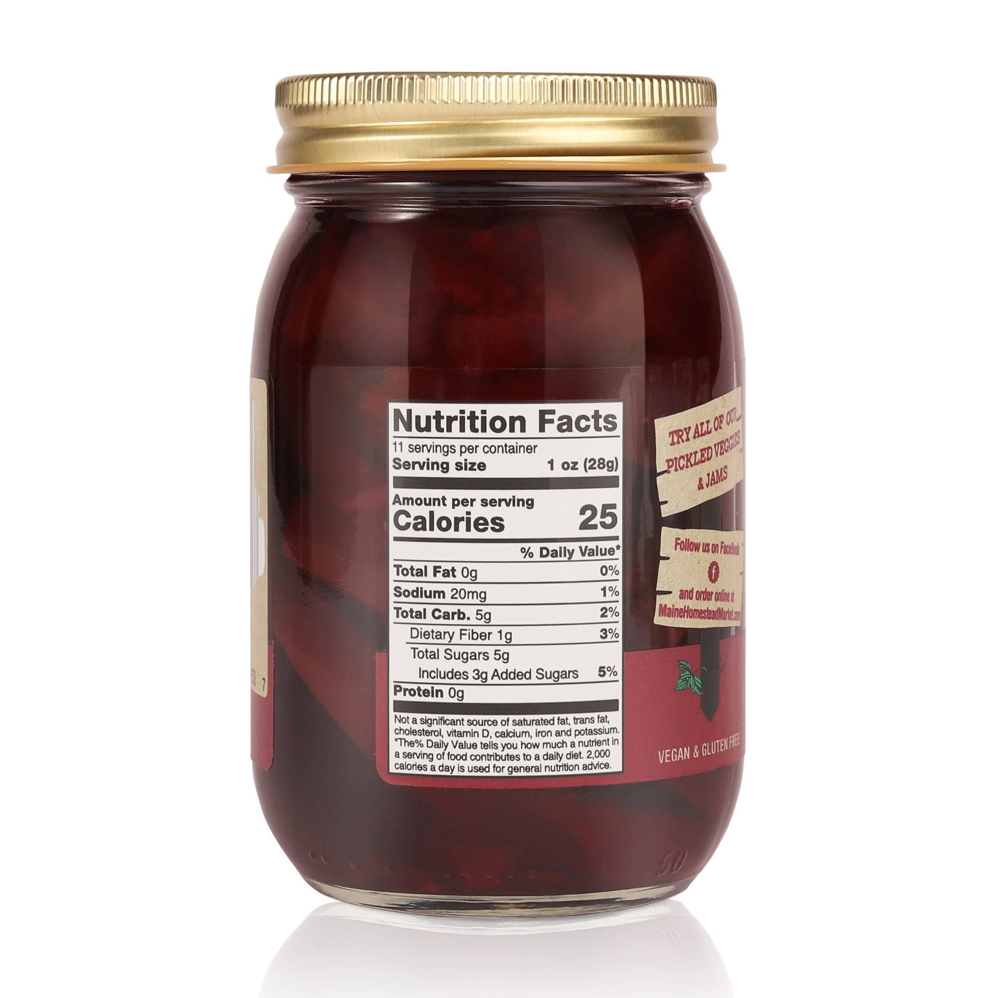 A glass jar of Red Envy Jam with a gold metal lid, showing the back of the label with nutrition facts and product details, on a white background.