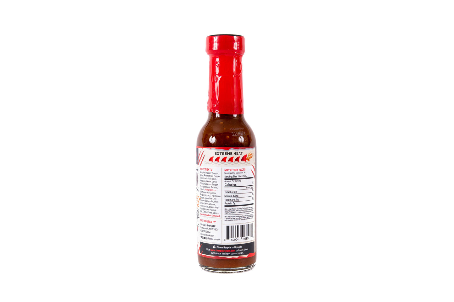 A bottle of hot sauce shown from the back, featuring a red cap, dark reddish-brown sauce inside, and a white label with red and black text.
