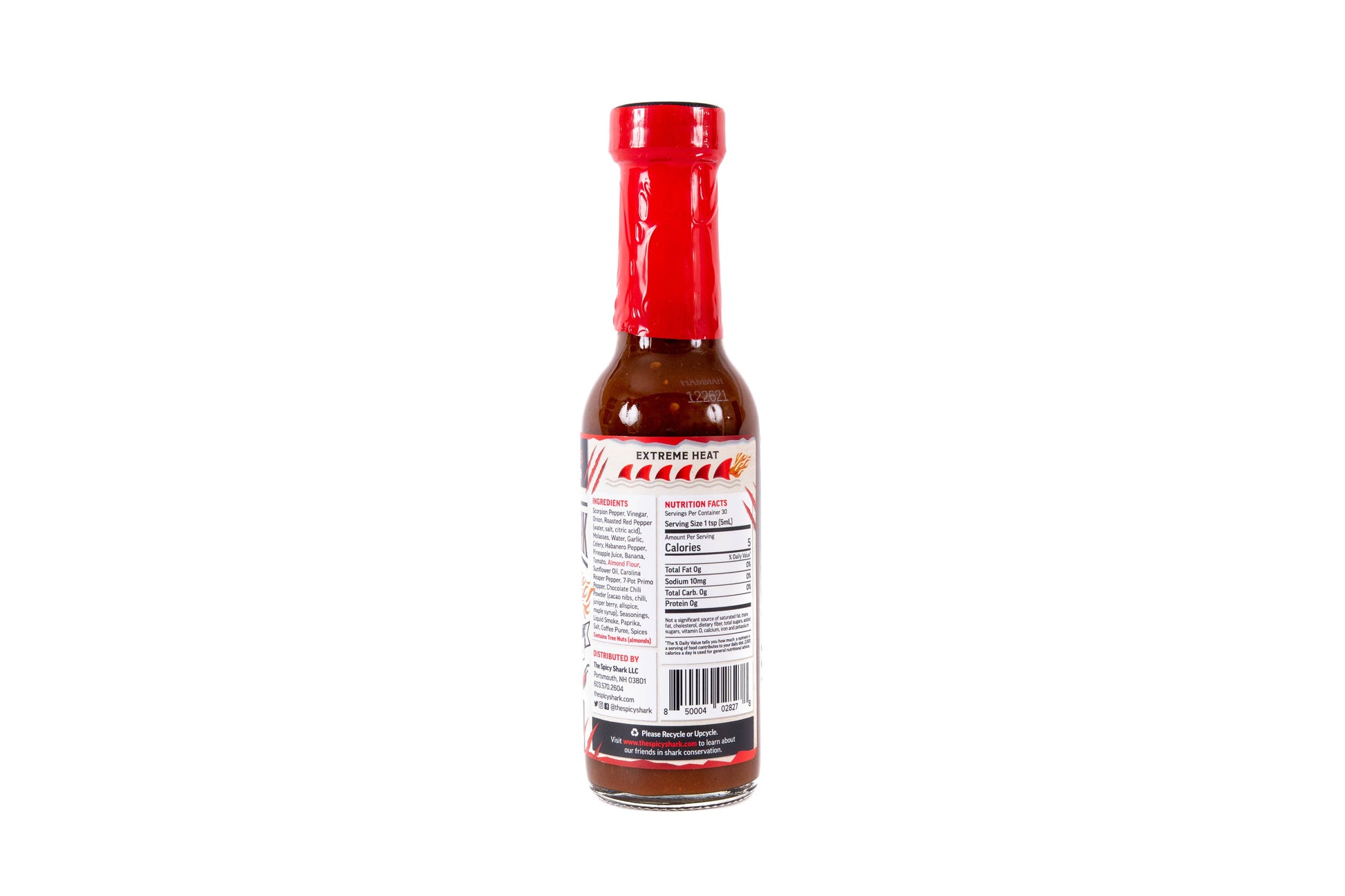 A bottle of hot sauce shown from the back, featuring a red cap, dark reddish-brown sauce inside, and a white label with red and black text.