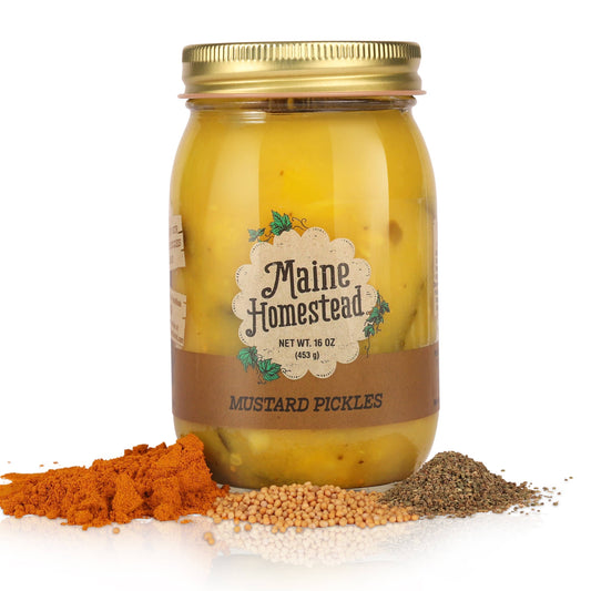 Jar of Maine Homestead mustard pickles with spices on a white background