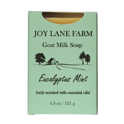 Joy Lane Farm Goat Milk Soap in Eucalyptus Mint scent, shown in its mint green cardboard packaging with black text and a small illustration of a farm scene.