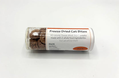 A clear plastic tube of Duck Freeze Dried Cat Bites, showing the brown freeze-dried treats inside, with a white and orange label, on a plain white background.