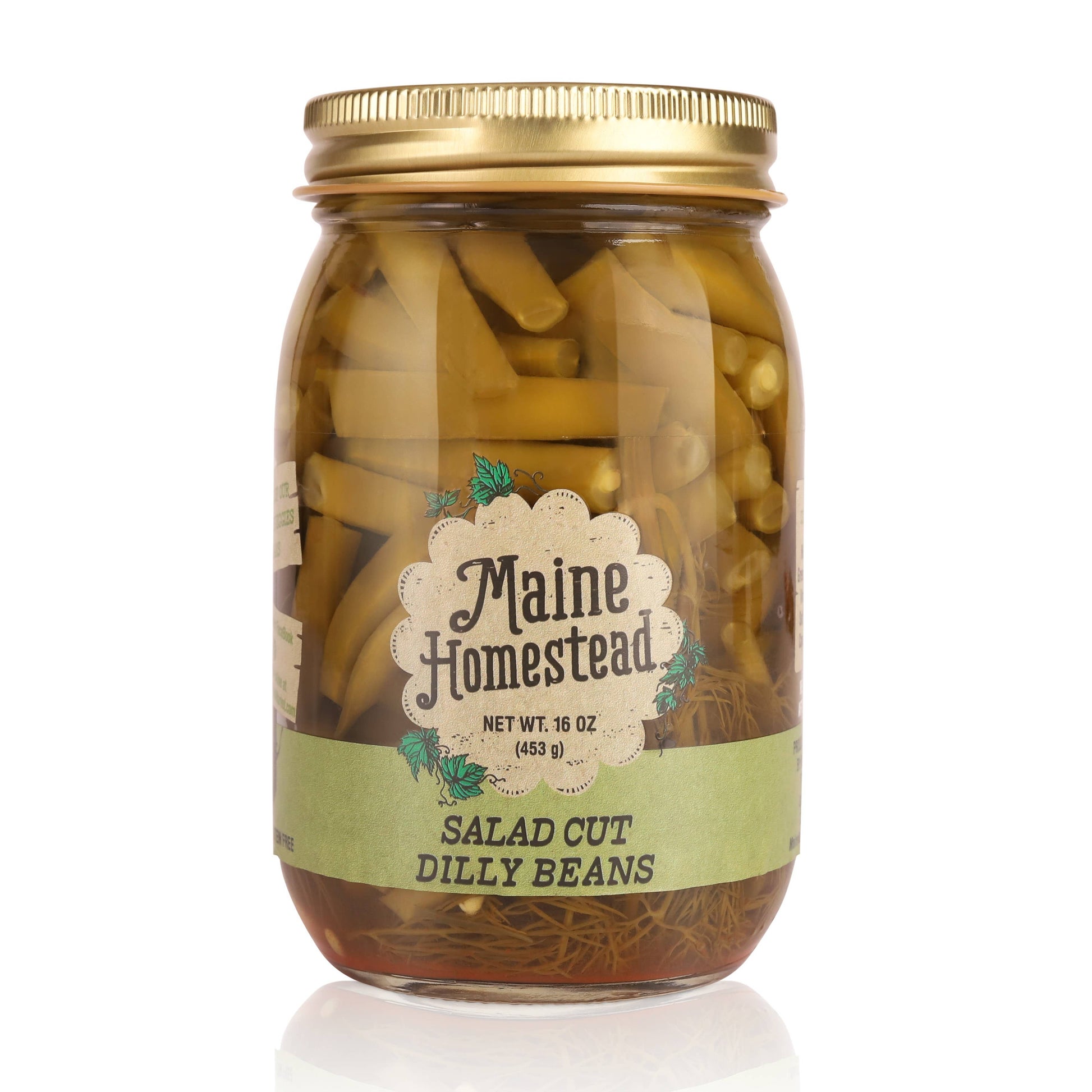 A glass jar of Maine Homestead Salad Cut Dilly Beans with a gold metal lid and a light green label, set against a plain white background.