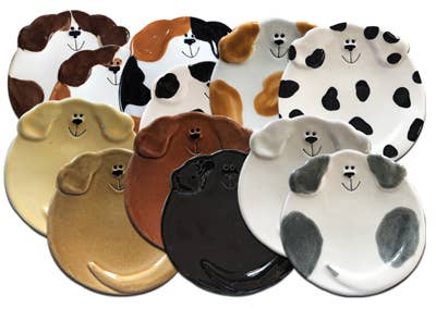 Set of dog-shaped plates in various colors on a white background