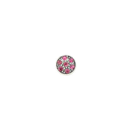 A single round silver-toned buttonhole connector or decorative button featuring a central cluster of pink gemstones surrounded by a beaded silver border, set against a plain white background.