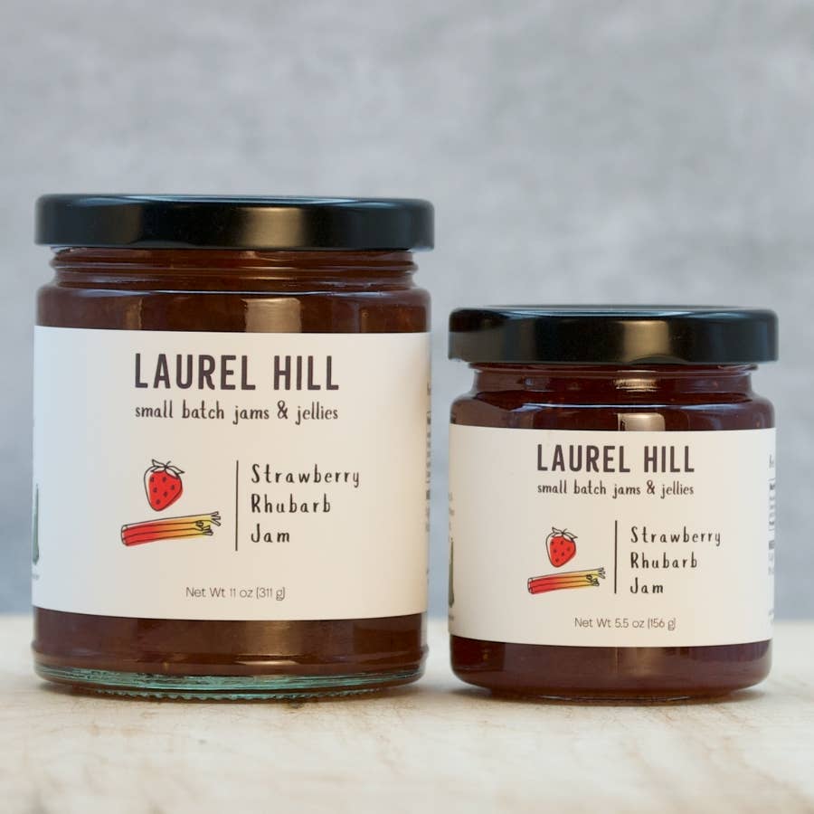 Two jars of Laurel Hill strawberry rhubarb jam on a neutral background