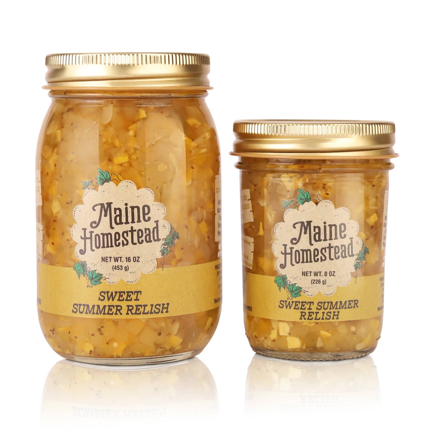 Two glass jars of Maine Homestead Sweet Summer Relish with gold metal lids, shown in 16 oz and 8 oz sizes on a white background with a soft reflection.