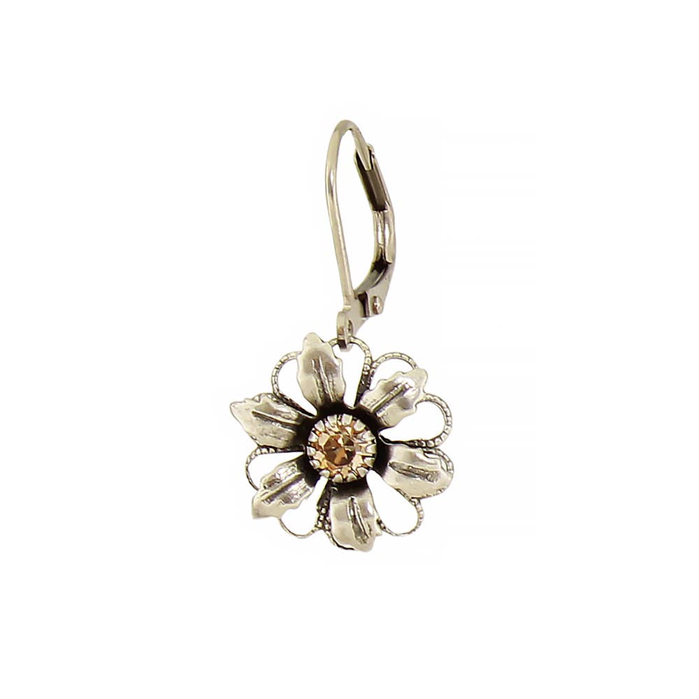 Silver flower-shaped earring with a central gemstone on a white background