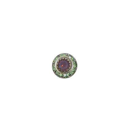 Round decorative element with purple center and green border on a white background