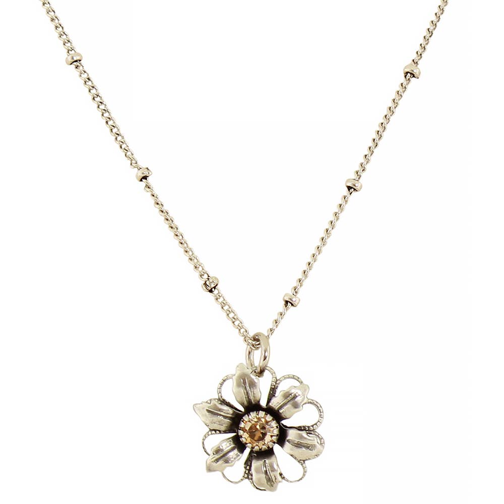 A silver-toned flower pendant necklace on a delicate chain, featuring a small round amber-colored center stone, shown against a plain white background.