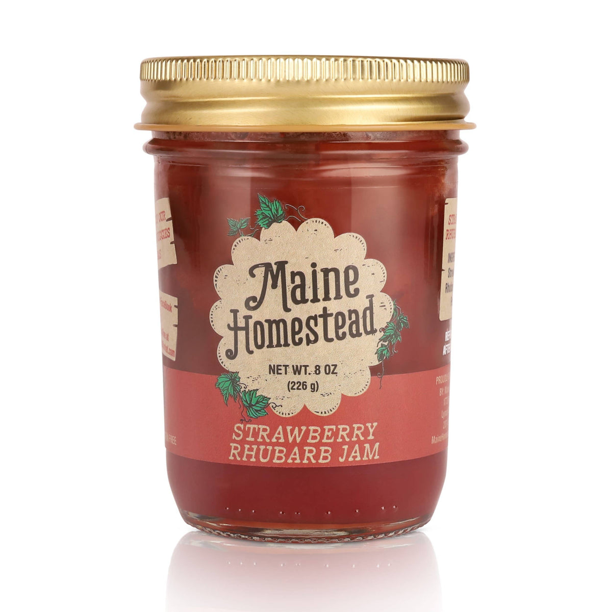 Jar of Maine Homestead Strawberry Rhubarb Jam with a gold lid on a white background