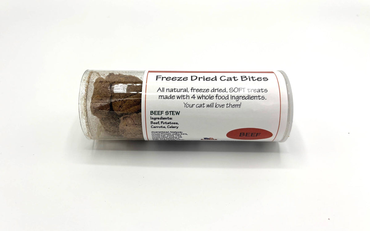 A clear plastic tube of freeze dried cat treats with a white paper label that reads 'Freeze Dried Cat Bites' and 'BEEF Stew' on a white background.