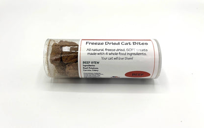 A clear plastic tube of freeze dried cat treats with a white paper label that reads 'Freeze Dried Cat Bites' and 'BEEF Stew' on a white background.