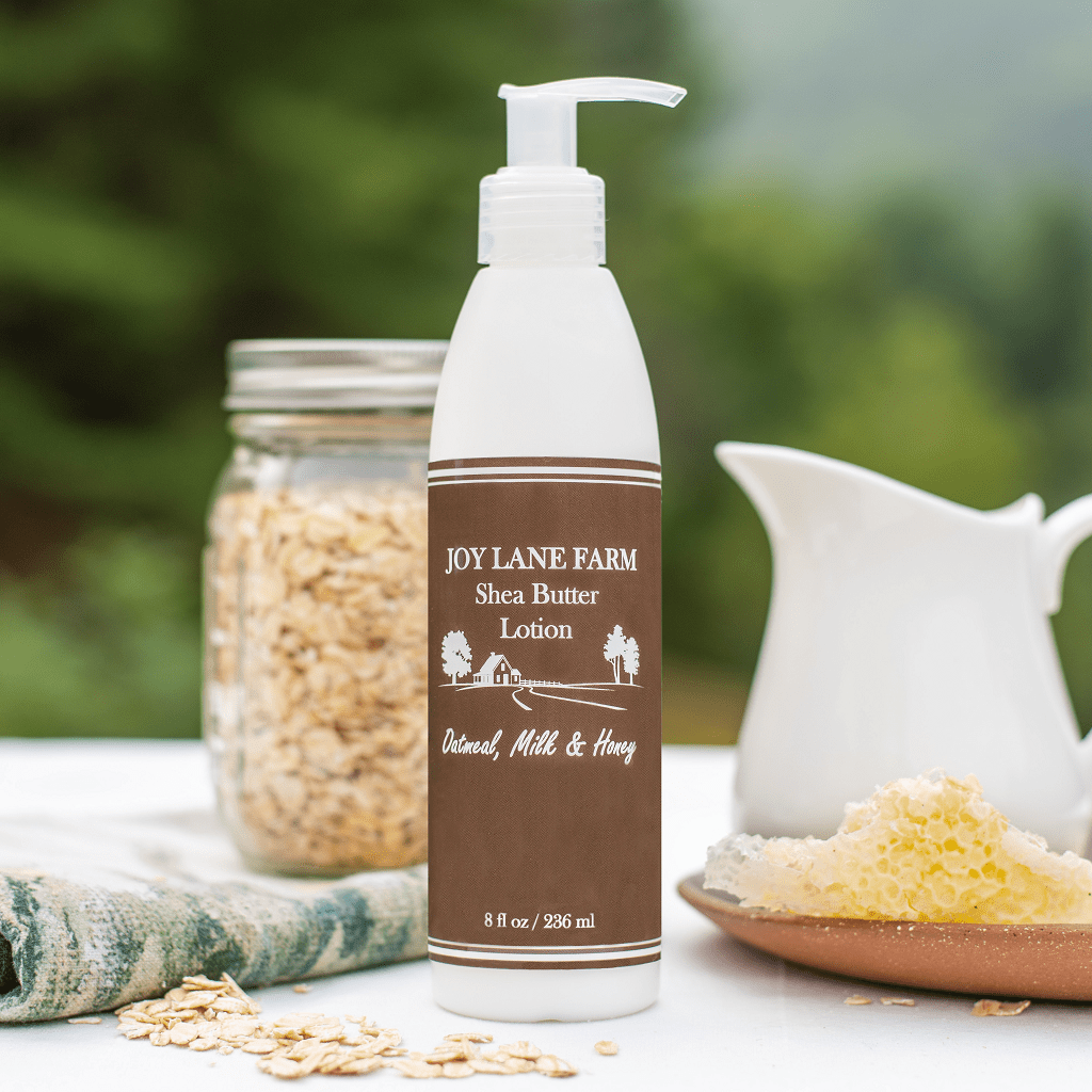 Joy Lane Farm shea butter lotion bottle with oats and a jar in the background