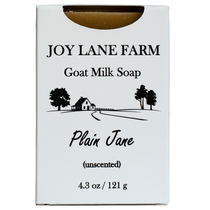 A white rectangular box of Joy Lane Farm Goat Milk Soap, Plain Jane, unscented, with black text and a small farm illustration on the front.