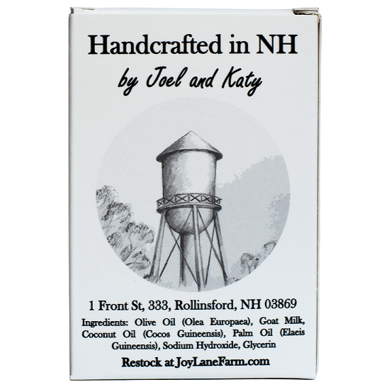 Front-facing product box with the text 'Handcrafted in NH by Joel and Katy' and a grayscale water tower illustration. The box also includes the address '1 Front St, 333, Rollinsford, NH 03869' and ingredients listed at the bottom, plus 'Restock at JoyLaneFarm.