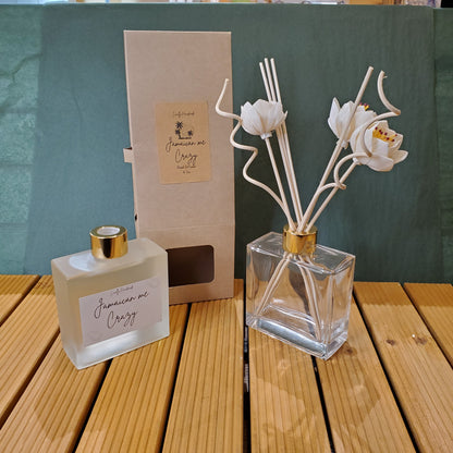 Perfume bottle with floral design on a wooden surface