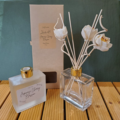 Decorative diffuser with floral design on a wooden surface