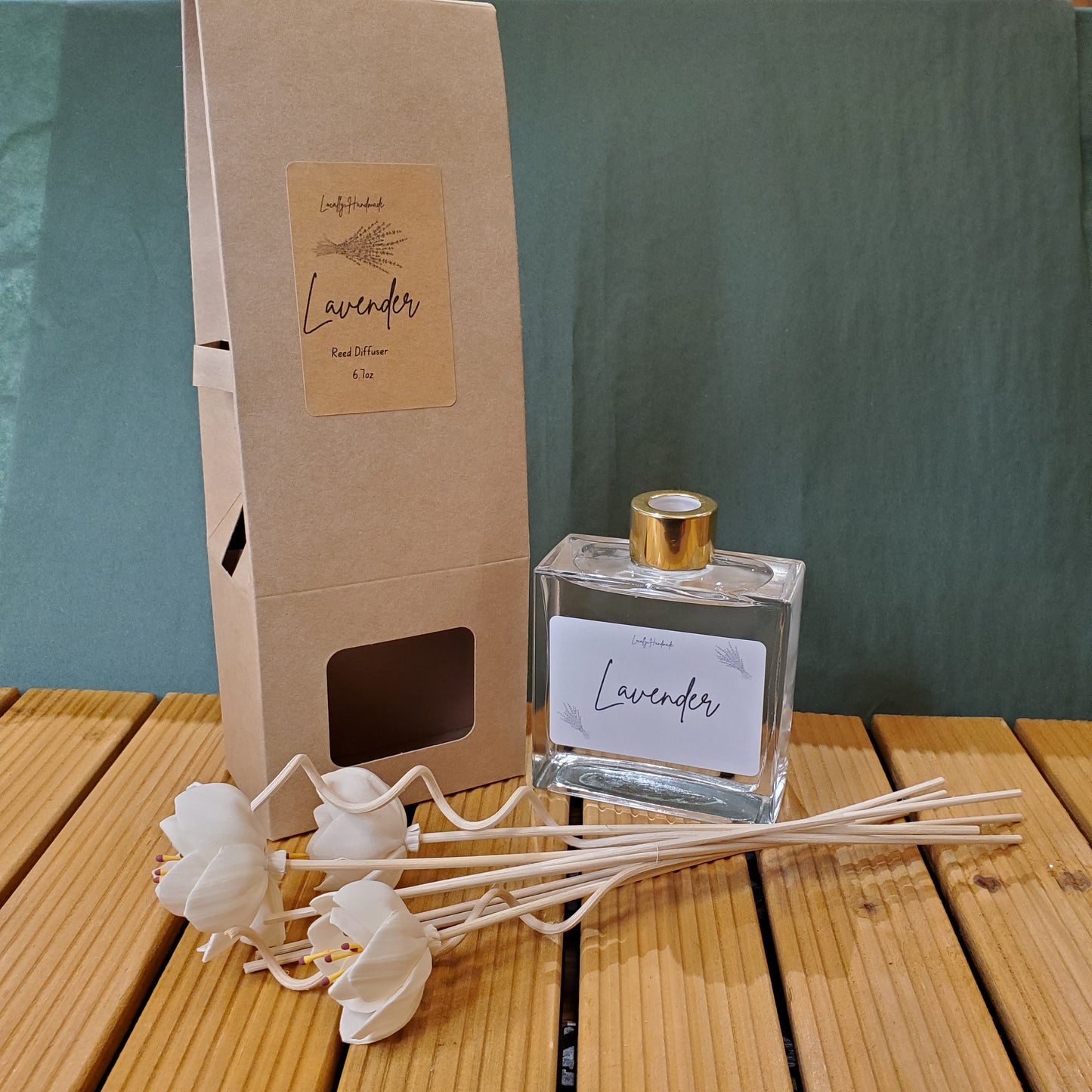 Lavender diffuser set with bottle and reeds on a wooden surface
