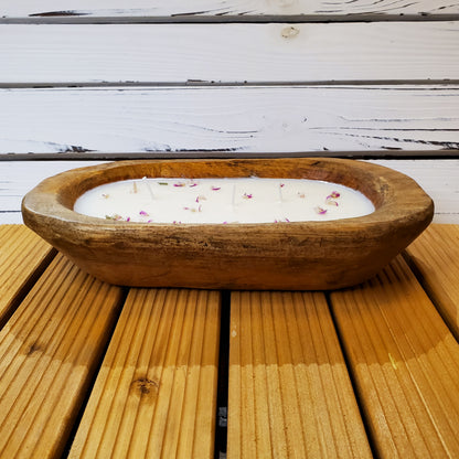 Wooden bowl with a candle on a wooden surface