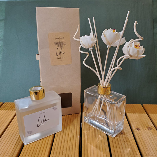 Decorative flower vase with a gold base on a green surface