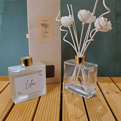 Perfume bottle with floral design on a wooden surface