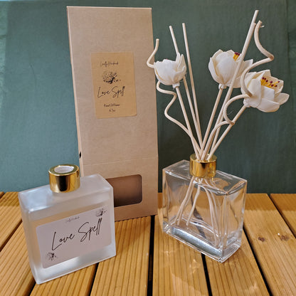 Decorative diffuser with floral design on a wooden surface