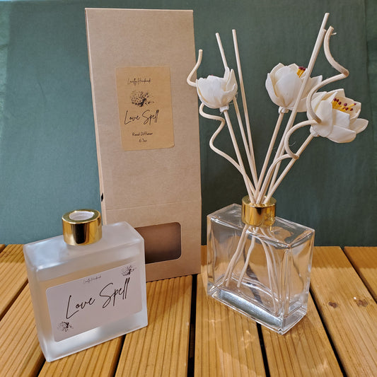 Decorative diffuser with floral design on a wooden surface