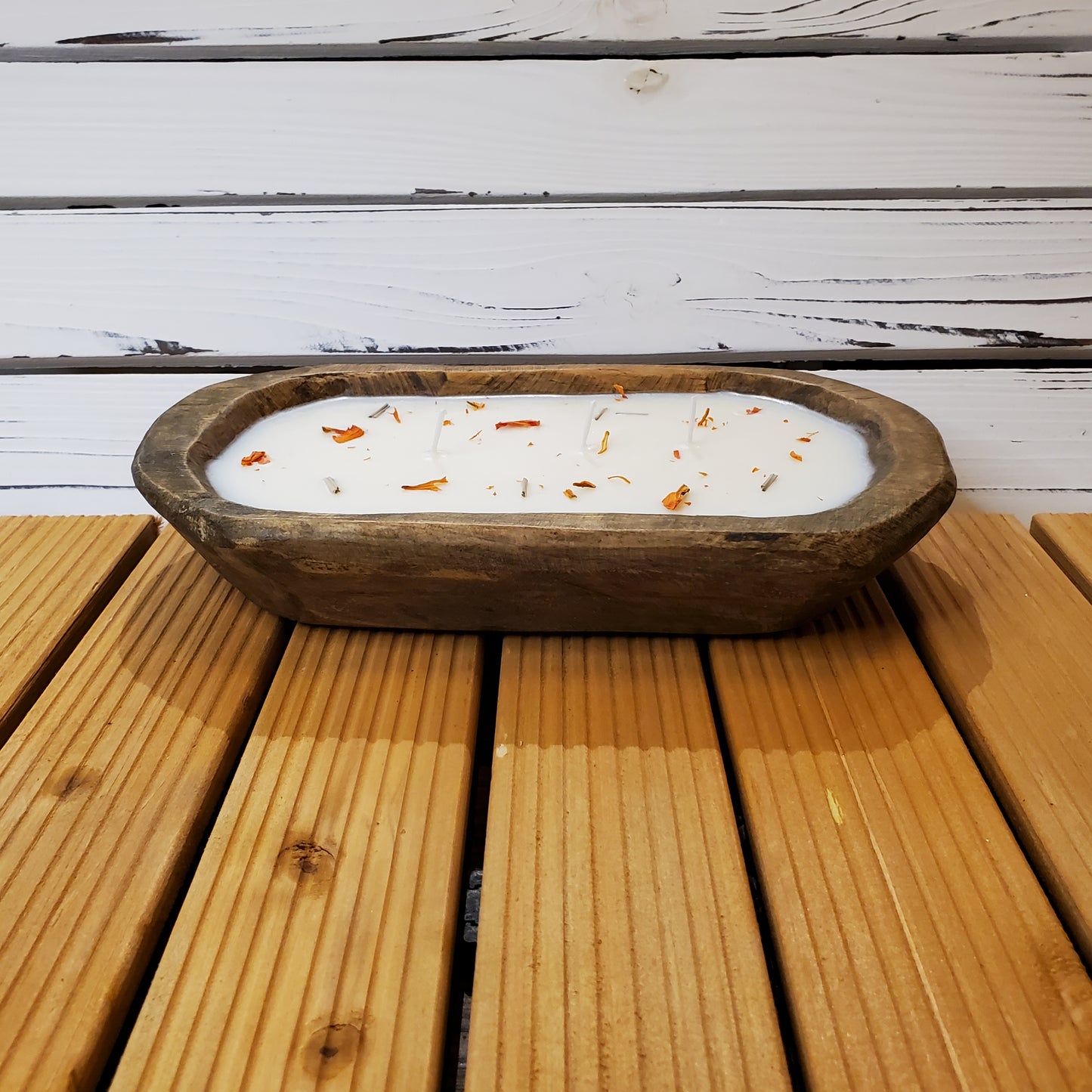 Wooden bowl with a candle on a wooden surface