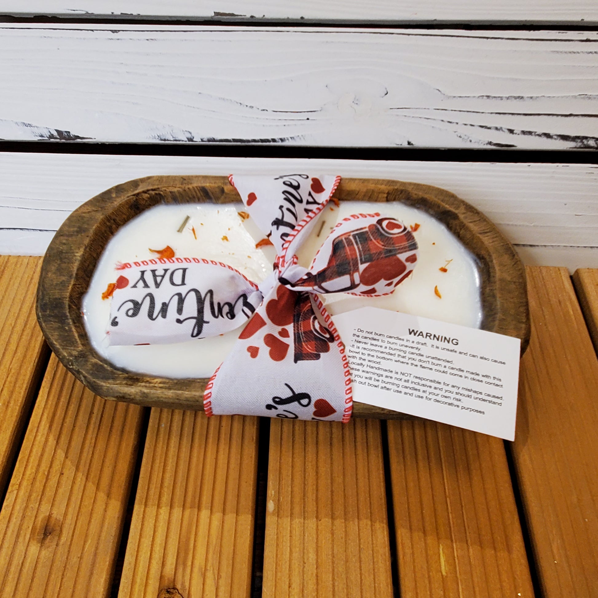 Decorative items with 'Valentine's Day' text on a wooden surface