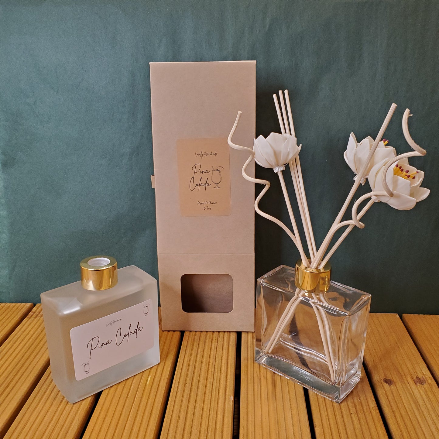 Perfume bottle with floral design and packaging on a textured surface