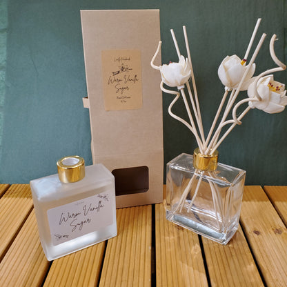 Perfume bottle with gold cap and clear glass, placed on a wooden surface.