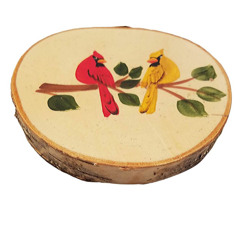 A round coaster made from birch tree slice with a hand-painted design featuring two cardinals on branches.