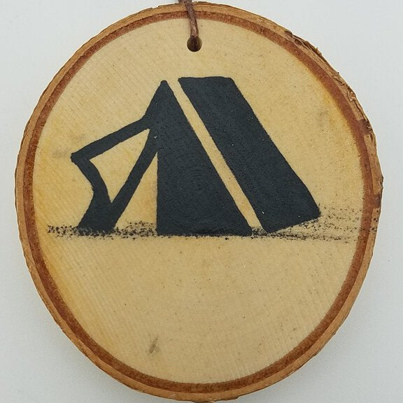 Wooden ornament with black symbol on a white background